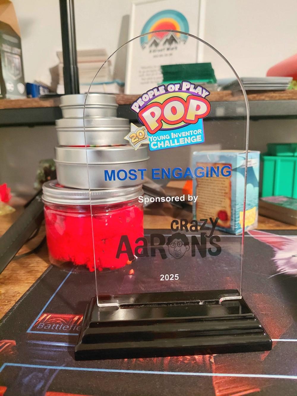 The Clipped Studios workbench with the People of Play Most Engaging Game award